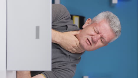 Vertical-video-of-Home-office-worker-man-has-neck-pain.
